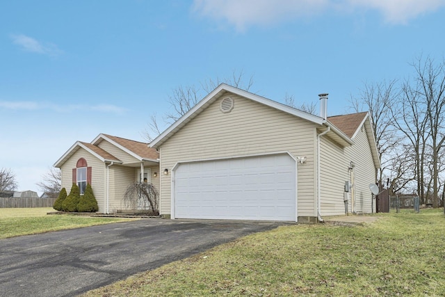 ranch-style house with driveway, an attached garage, fence, and a front yard