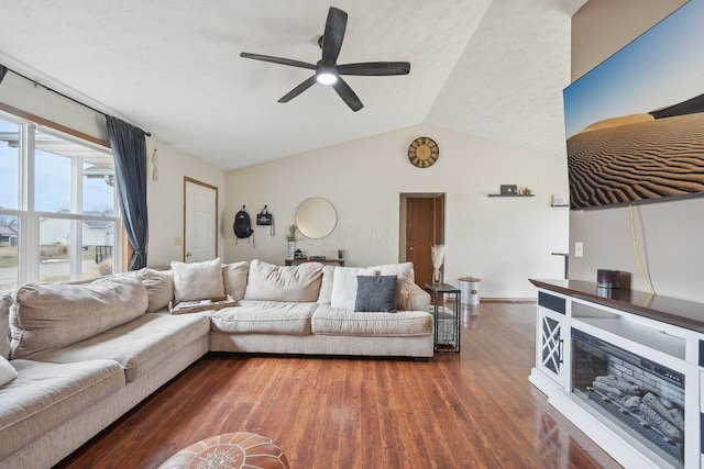 living room with lofted ceiling, a ceiling fan, and dark wood-type flooring