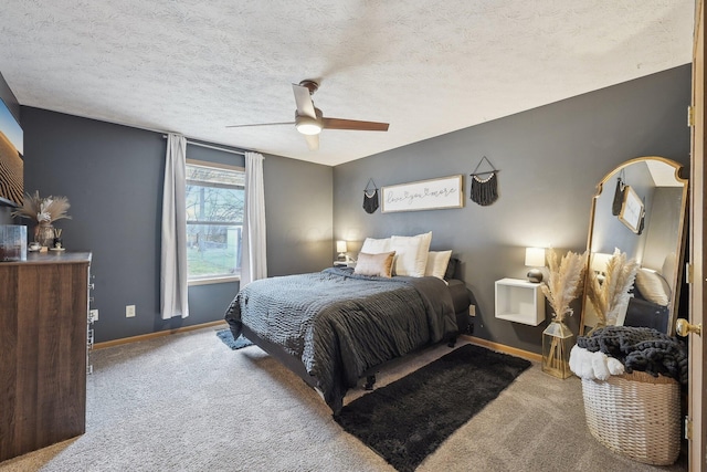 bedroom featuring light carpet, a textured ceiling, a ceiling fan, and baseboards