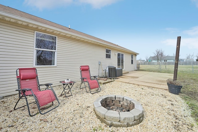 back of house with a patio area, an outdoor fire pit, fence, and cooling unit