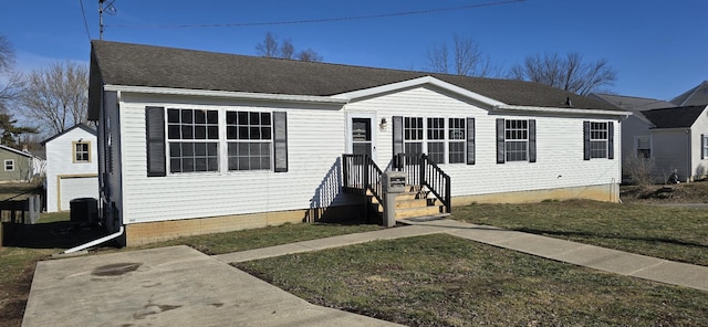 view of front of house with cooling unit and a front lawn