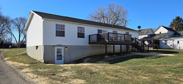 back of property with a yard and a deck