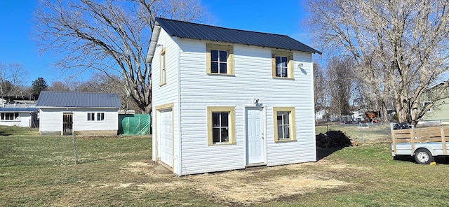 rear view of house with a yard and a shed