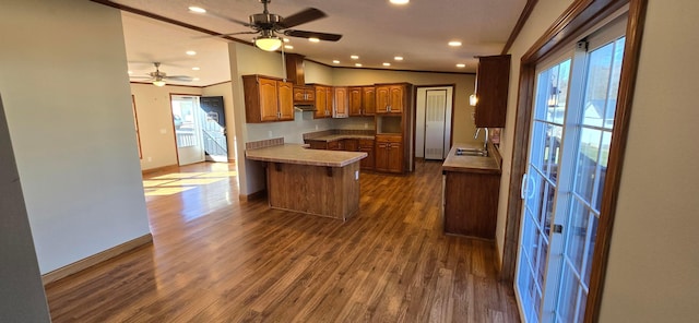 kitchen with lofted ceiling, sink, plenty of natural light, dark hardwood / wood-style flooring, and kitchen peninsula