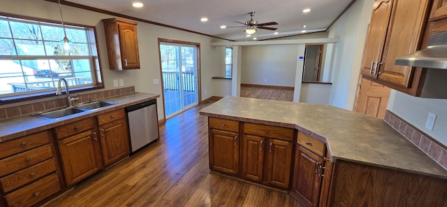 kitchen featuring sink, hanging light fixtures, ornamental molding, dark hardwood / wood-style flooring, and stainless steel dishwasher