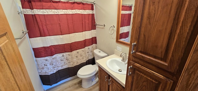 bathroom featuring a shower with curtain, vanity, wood-type flooring, and toilet