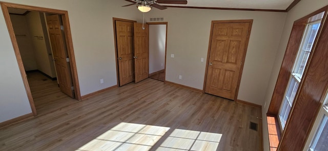 unfurnished bedroom with crown molding, ceiling fan, and light hardwood / wood-style floors