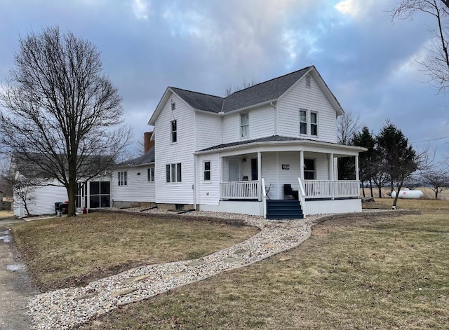 farmhouse-style home featuring a front lawn and a porch