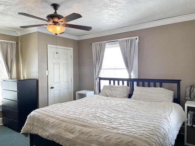 carpeted bedroom featuring ceiling fan, ornamental molding, and a textured ceiling