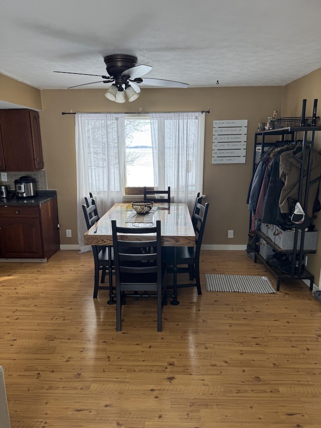 dining space featuring ceiling fan and light hardwood / wood-style floors