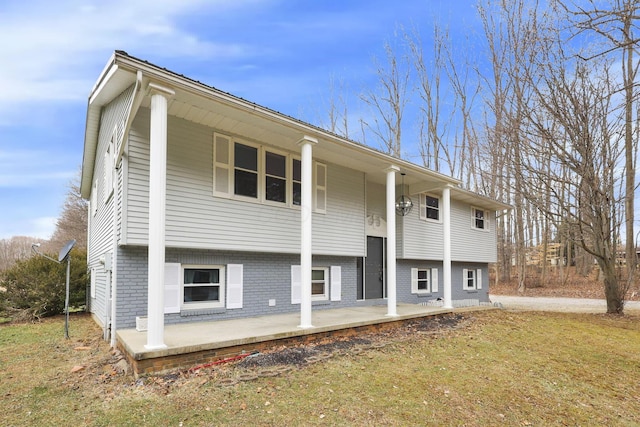 view of front facade with a front lawn and a patio