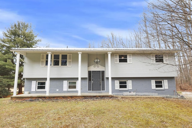 bi-level home featuring a front yard and a patio