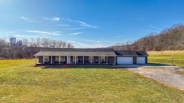 single story home with a garage, a front yard, and covered porch