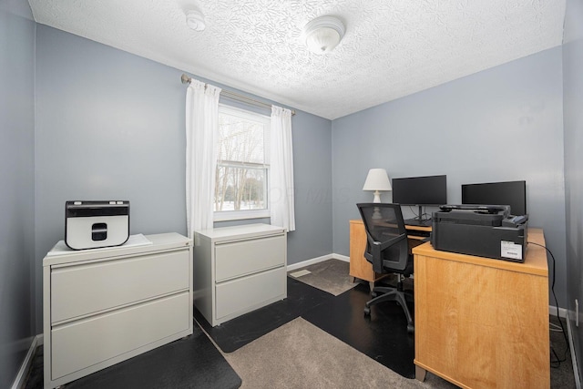 home office with a textured ceiling and baseboards