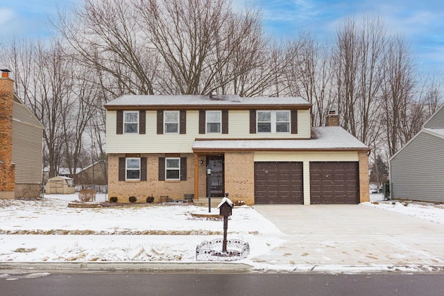 view of front of home with brick siding, driveway, a chimney, and an attached garage