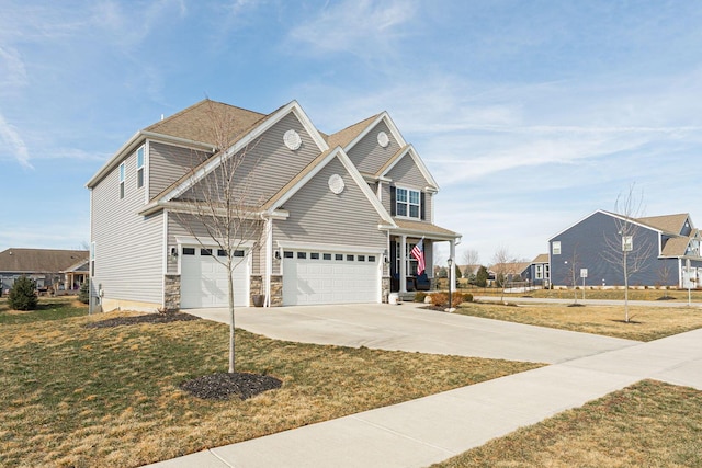 view of front of home with a garage and a front lawn