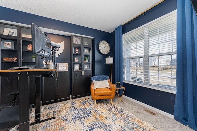 sitting room with carpet floors, bar area, and a textured ceiling