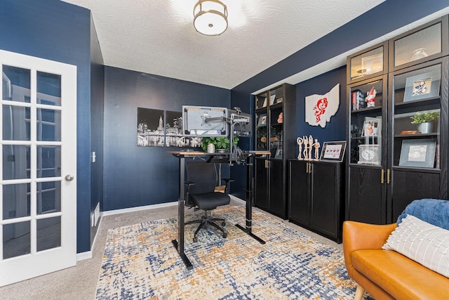 office with light carpet and a textured ceiling