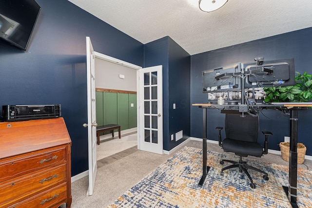 office space with light colored carpet, french doors, and a textured ceiling