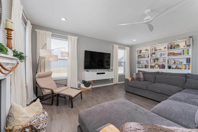 living room featuring hardwood / wood-style floors, a textured ceiling, a healthy amount of sunlight, and ceiling fan