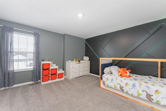 carpeted bedroom featuring a textured ceiling