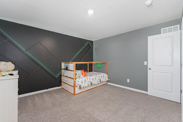 carpeted bedroom featuring a textured ceiling