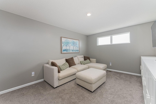 living room featuring light colored carpet and a textured ceiling