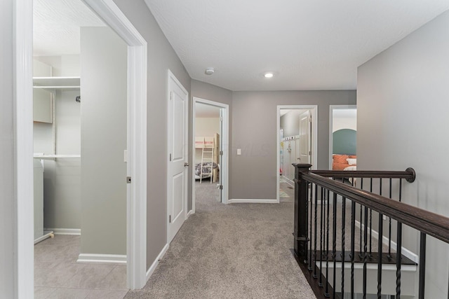 hallway with light colored carpet