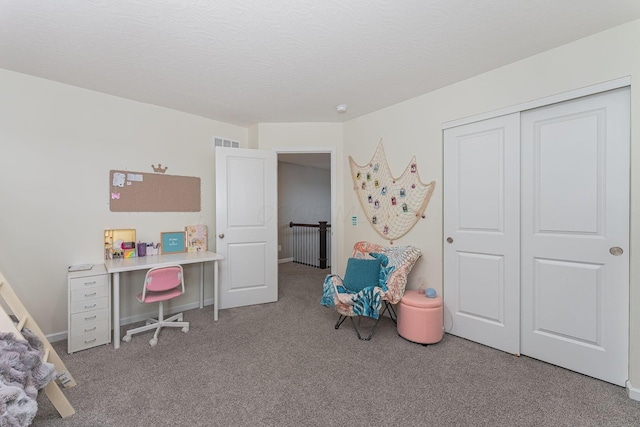 bedroom with a closet, light carpet, and a textured ceiling