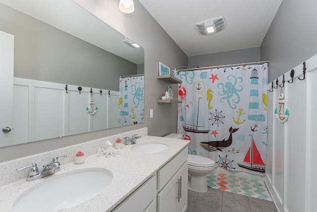 bathroom with vanity, curtained shower, tile patterned floors, and toilet