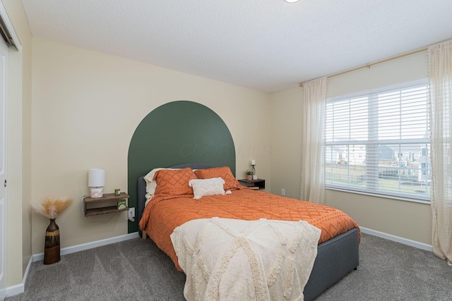 carpeted bedroom featuring a textured ceiling