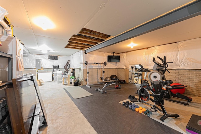 exercise room with brick wall