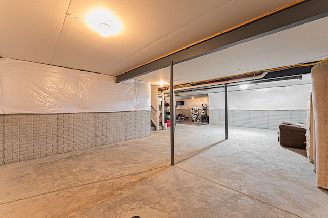 basement with brick wall