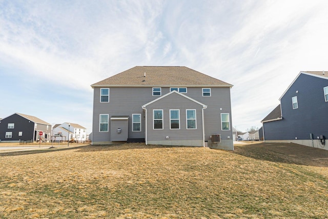 rear view of house with a yard