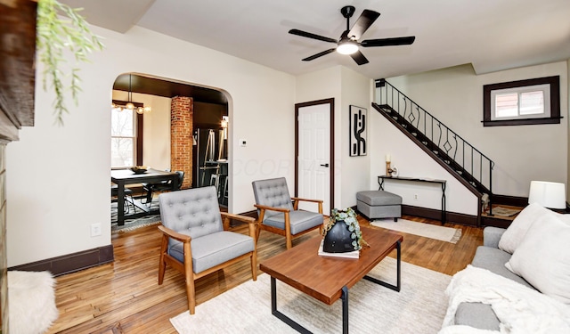 living room featuring ceiling fan and light hardwood / wood-style floors