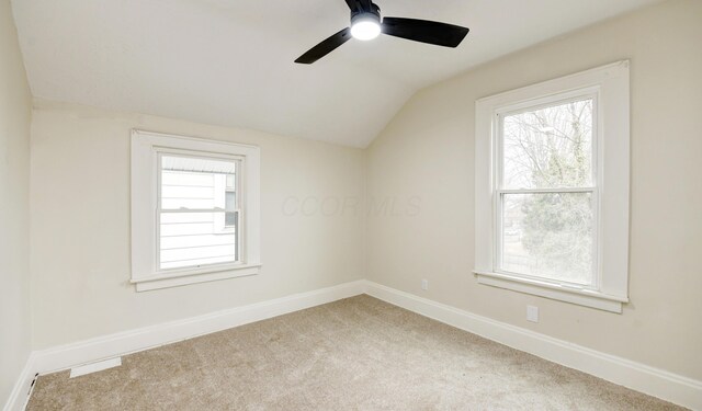 bonus room with ceiling fan, light colored carpet, plenty of natural light, and vaulted ceiling