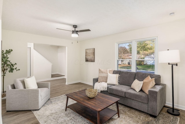 living room featuring ceiling fan and wood-type flooring