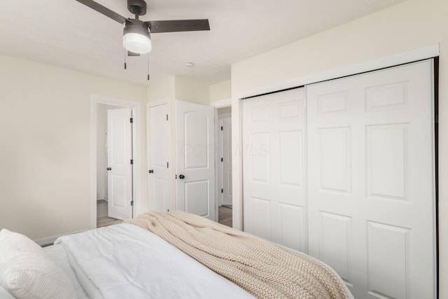 bedroom with ceiling fan and a closet