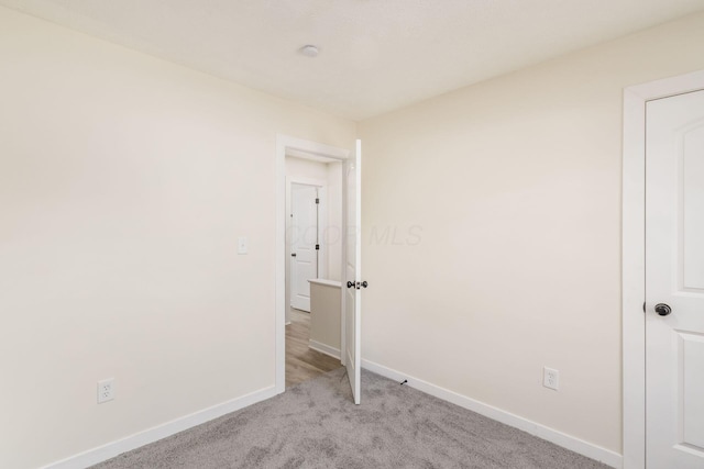 unfurnished bedroom with light colored carpet