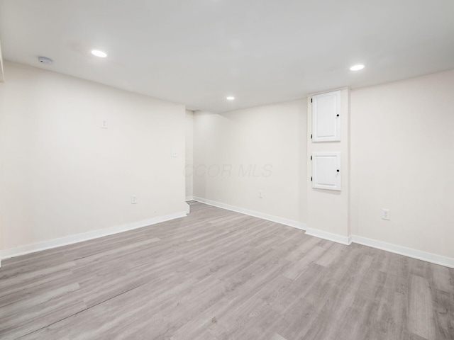 basement with light hardwood / wood-style flooring