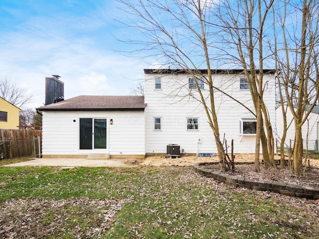 rear view of house with cooling unit, a yard, and a patio