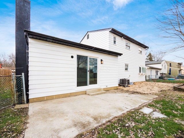 rear view of property featuring cooling unit and a patio area