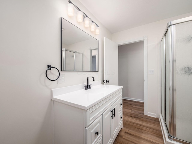 bathroom featuring vanity, a shower with door, and hardwood / wood-style floors