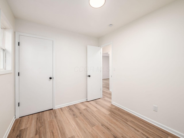 unfurnished bedroom with light wood-type flooring