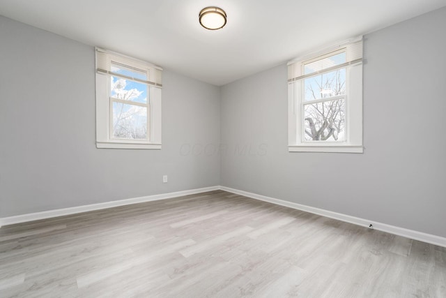 unfurnished room featuring plenty of natural light and light hardwood / wood-style flooring