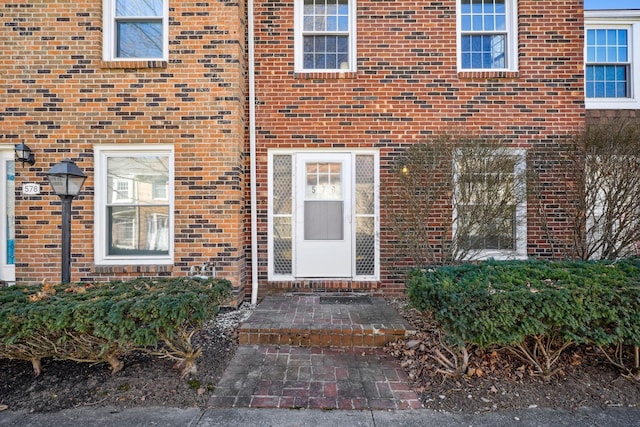 entrance to property with brick siding