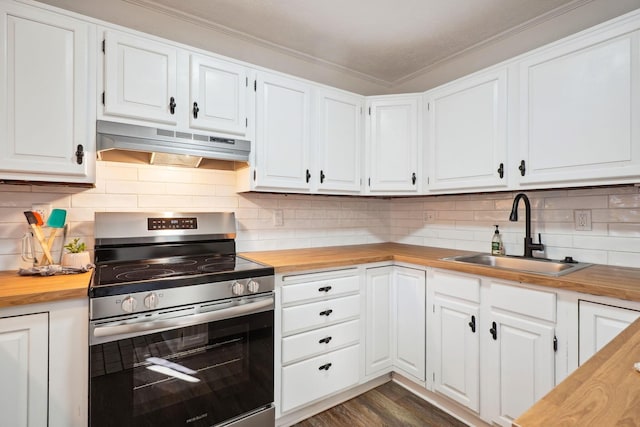 kitchen featuring under cabinet range hood, butcher block countertops, white cabinets, stainless steel electric stove, and a sink