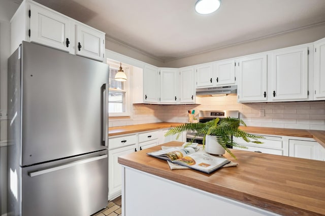 kitchen with appliances with stainless steel finishes, white cabinetry, and butcher block counters