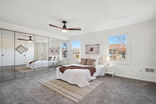 bedroom featuring carpet, multiple windows, baseboards, and visible vents