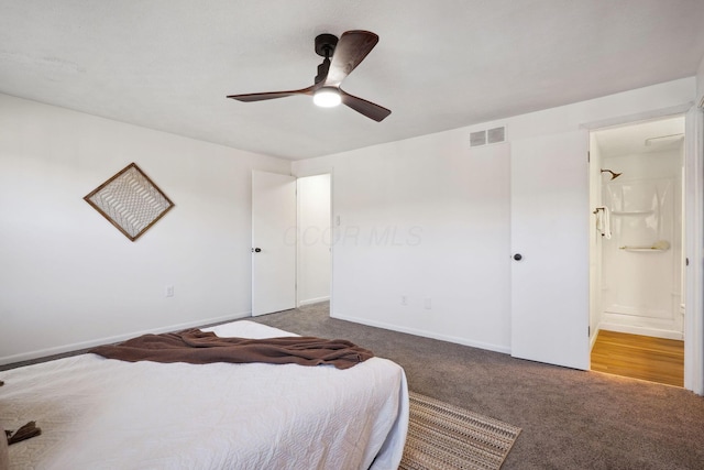 bedroom featuring visible vents, connected bathroom, dark colored carpet, ceiling fan, and baseboards